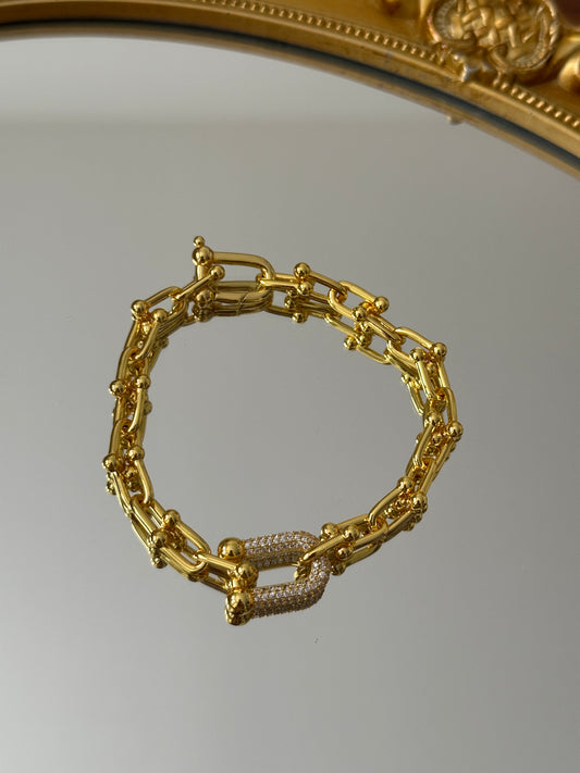 Gold bracelet with stone brooch